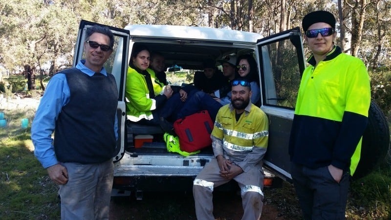 green army members sitting in the back of a van