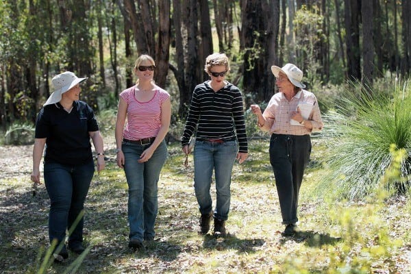 four women walking through a paddock in Jarrahdale for the Healthy Habitats program