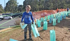 Child helps to plant at the National Tree Day Celebration