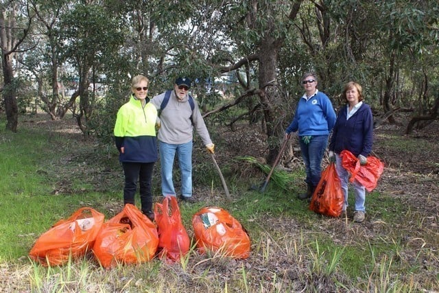 members of Byford Envirolink standing behind bags of rubbish collected in Byford, Western Australia