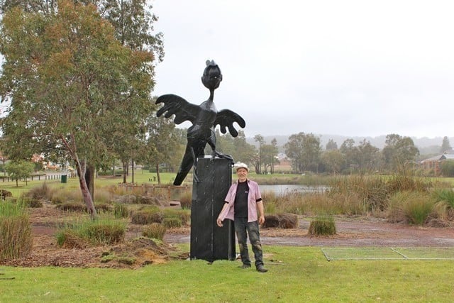 man with qquirky black cockatoo sculpture