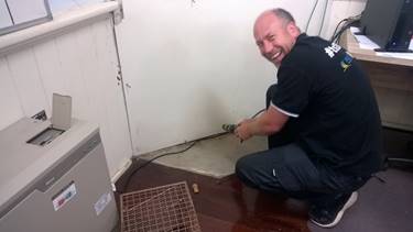 a man rescuing a possum