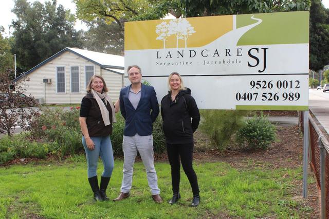two women and a man standing in front of Landcare SJ sign