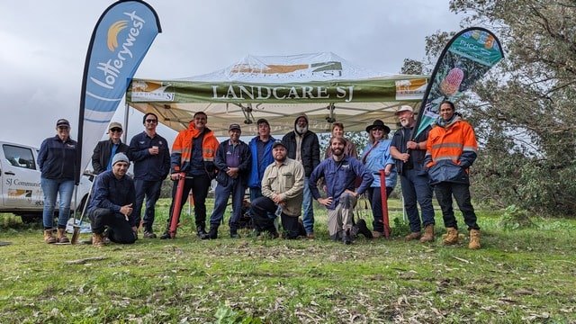 group of environmental attendees at planting site